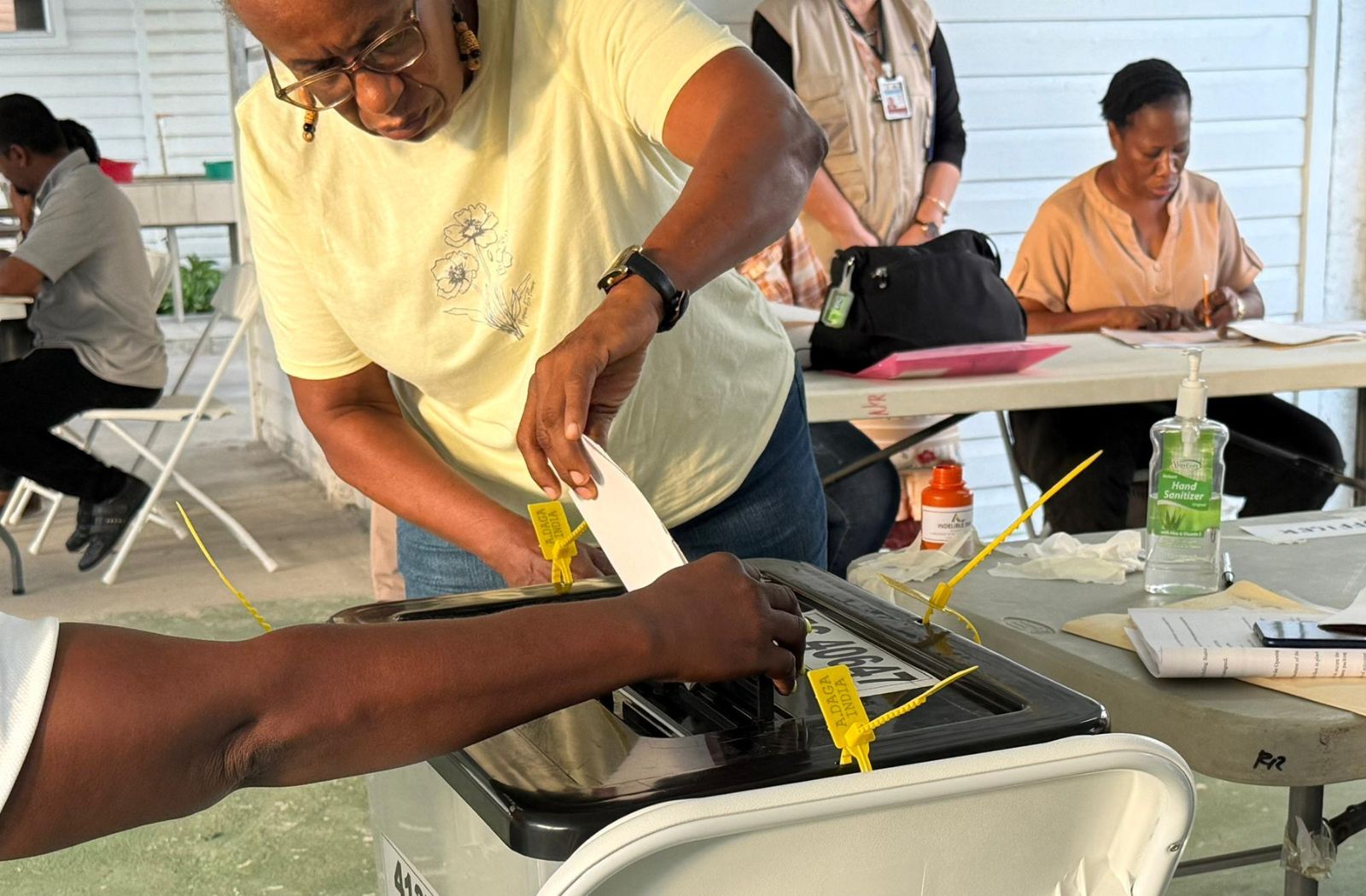 woman casting a vote at a polling station in Guyana