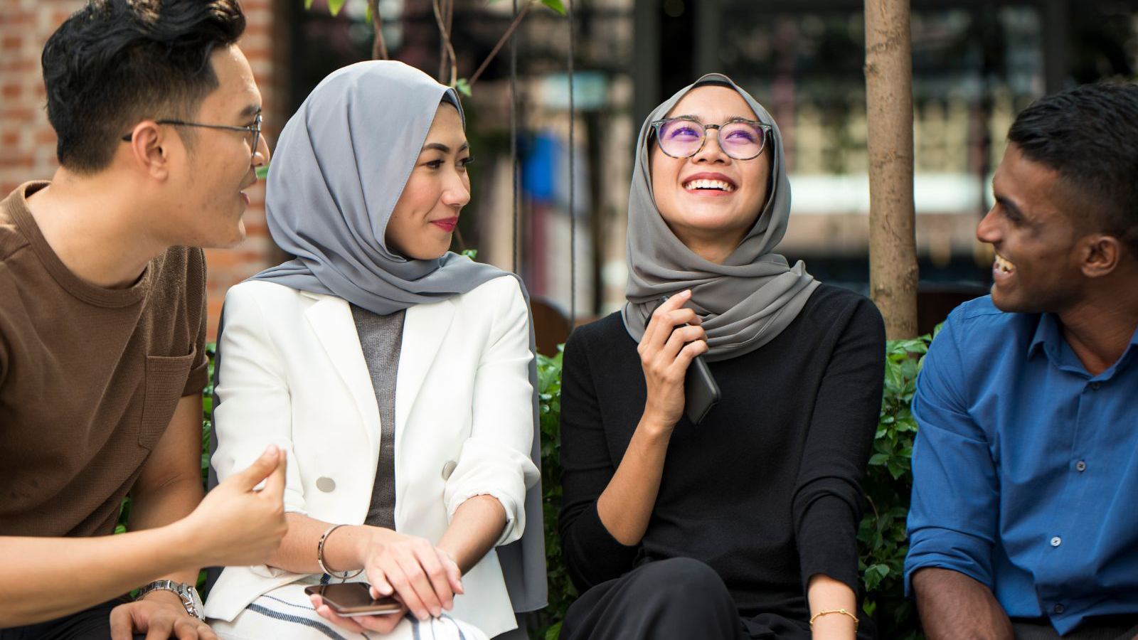 four young people talking